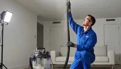 Technician cleaning air ducts for AC system in Fort Worth, TX home by Five Star Cooling